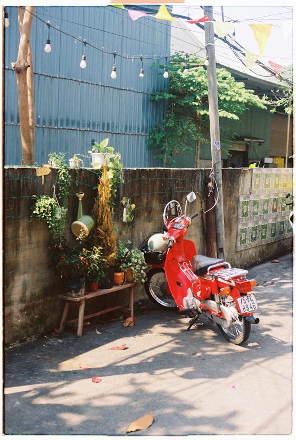 free photo of a red moped parked in front of a building 2
